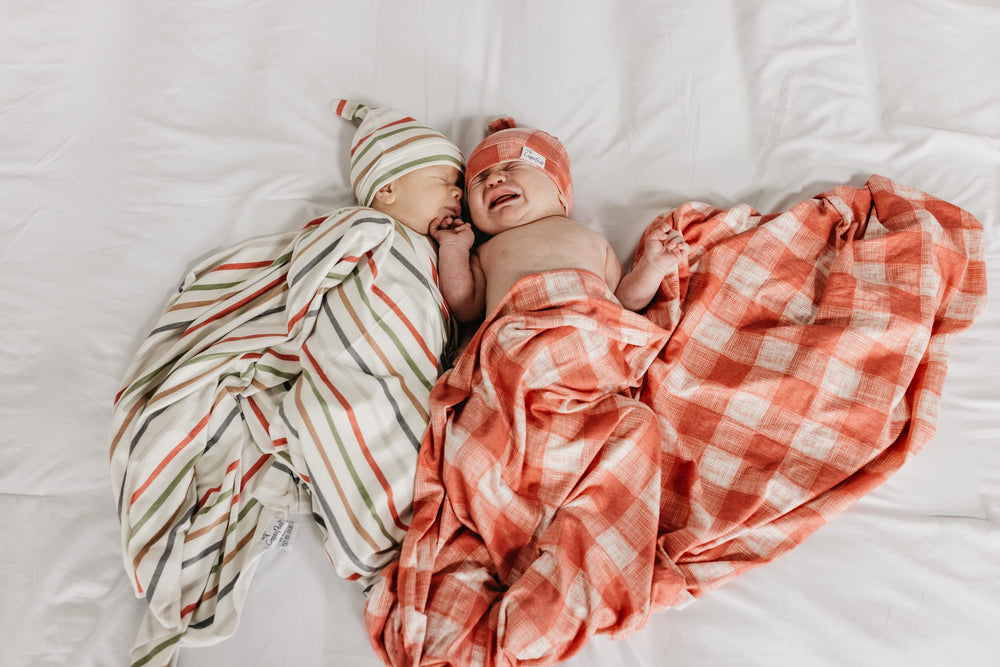 Copper Pearl Ralphie swaddle laid flat on bed ready for use.