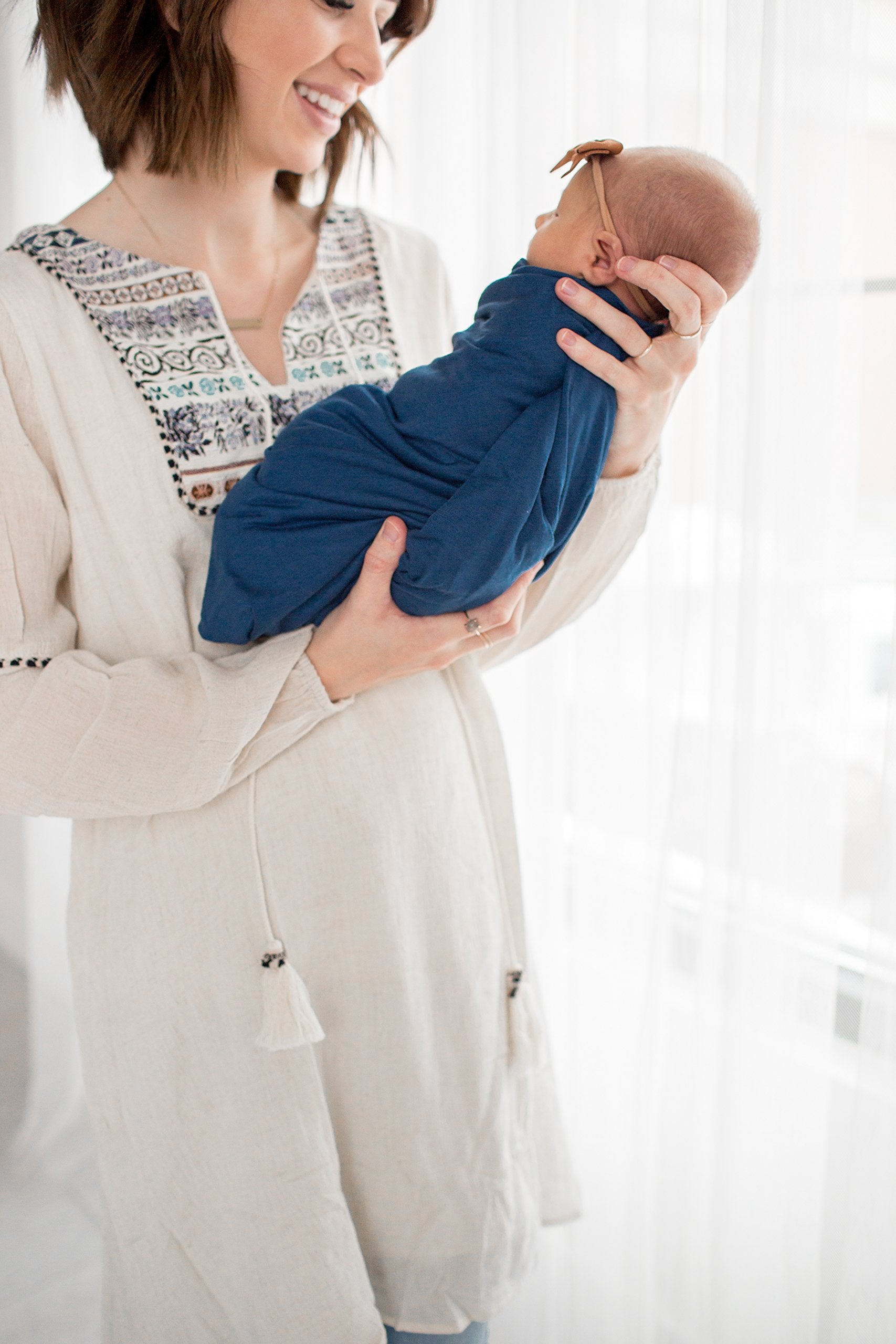 Copper Pearl River baby wrap in use as a cozy, portable wrap.