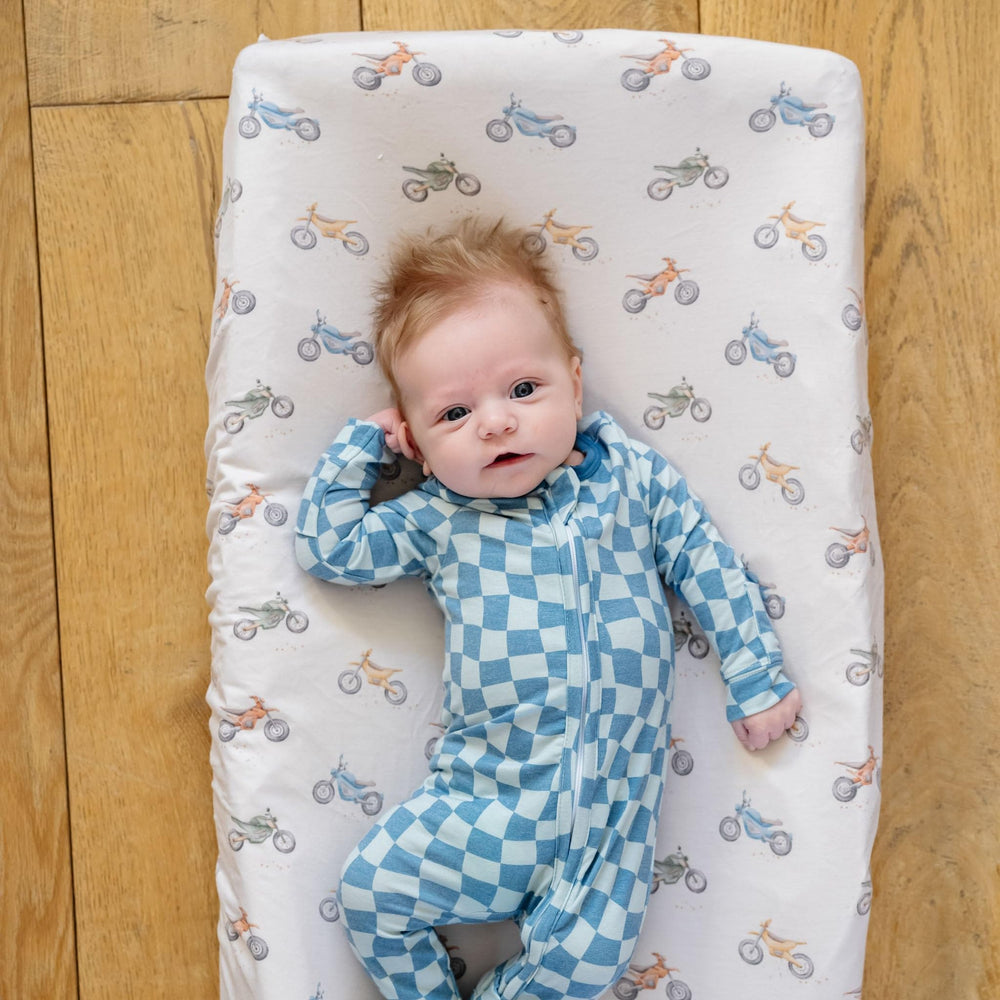 Copper Pearl Ryder knit cover coordinates with nursery decor for a cohesive look.