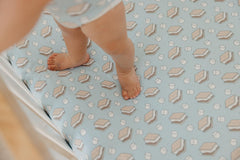Copper Pearl crib sheet in gift-ready packaging for new parents