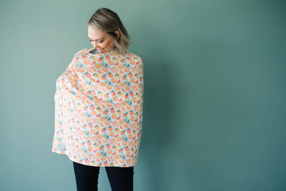 Copper Pearl shopping cart cover citrus keeps baby comfortable and clean during outings.