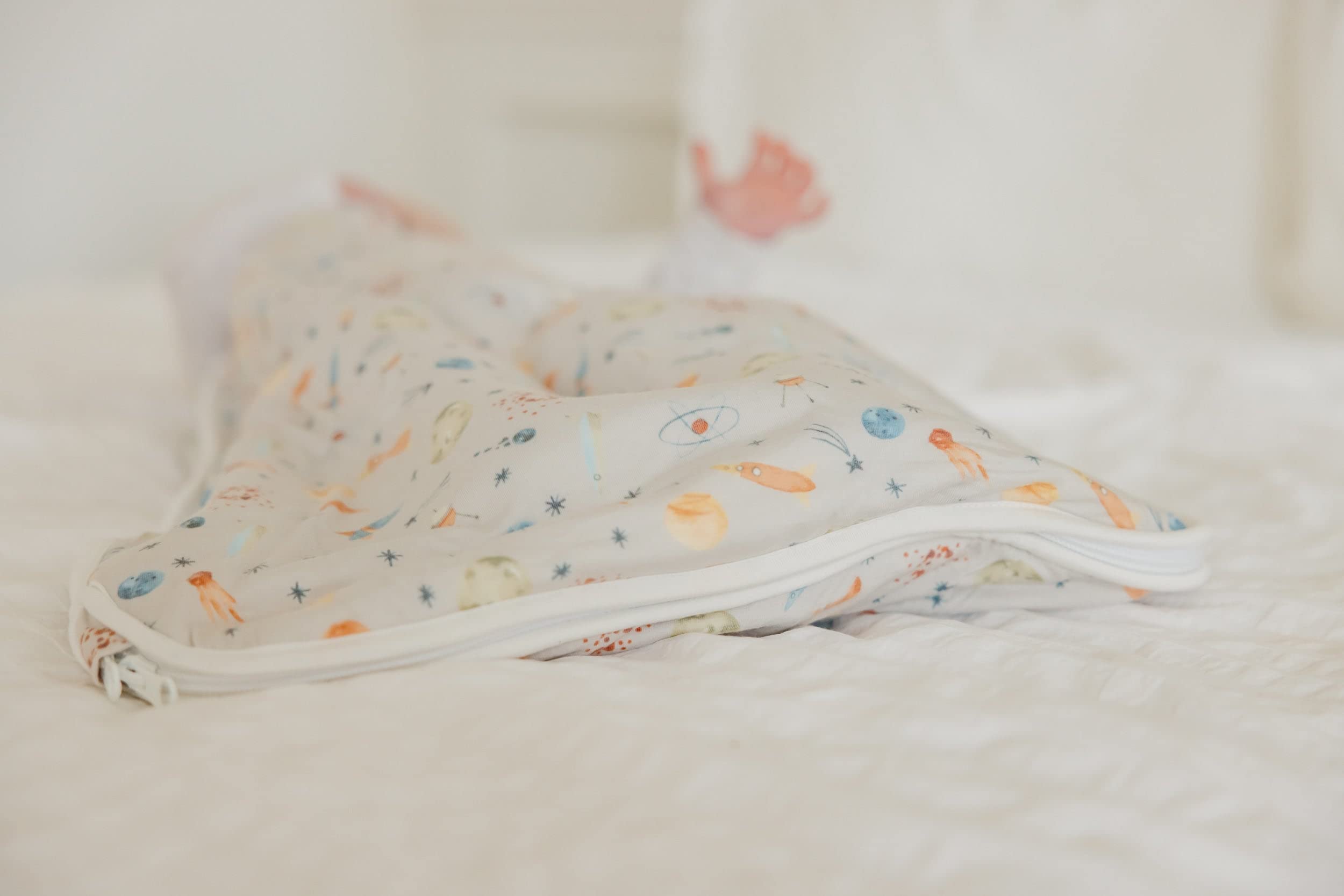 Copper Pearl Sleep Sack cosmos pattern adds stylish nursery decor.