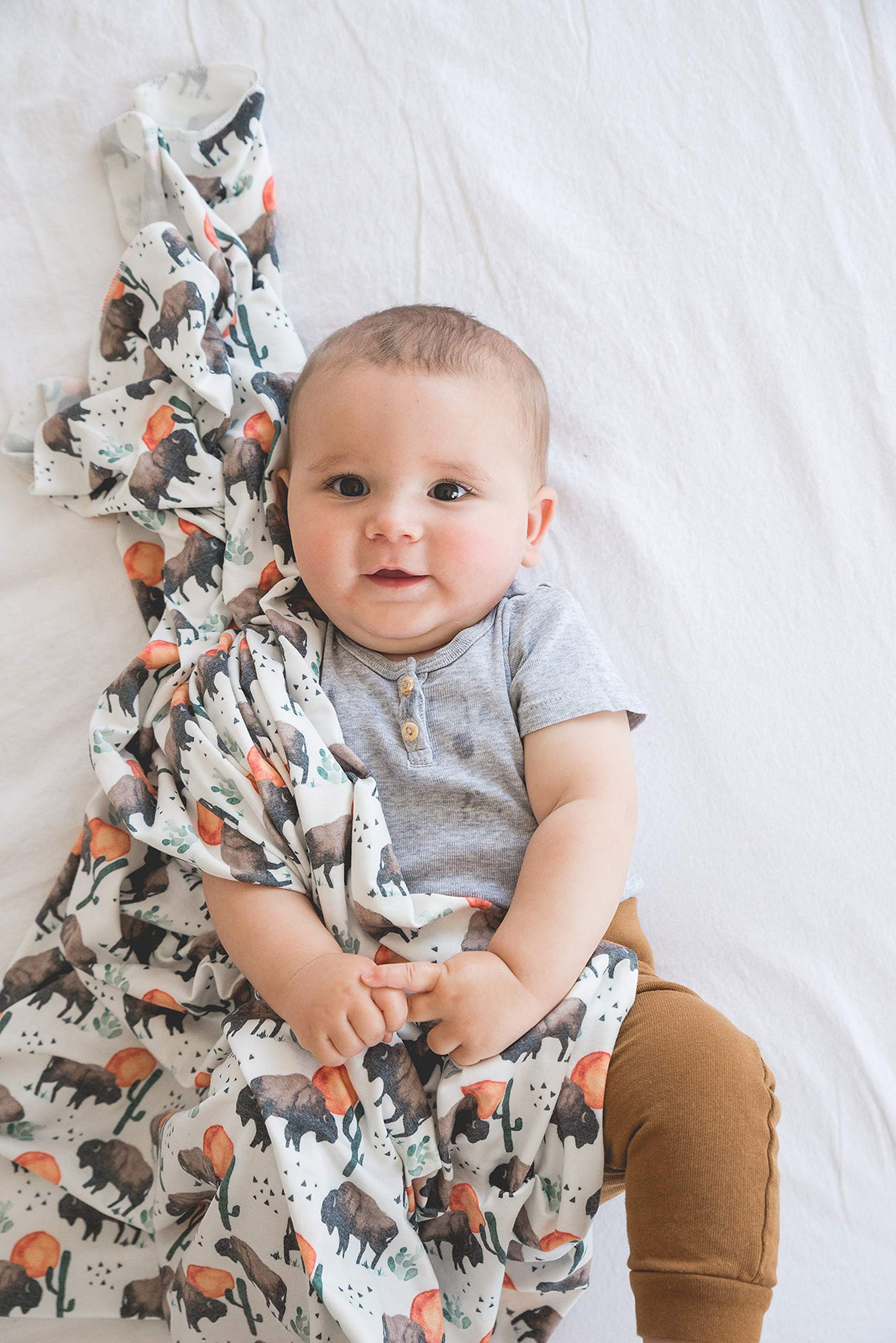 Copper Pearl soft knit blanket presented as a cuddle prop for photos.