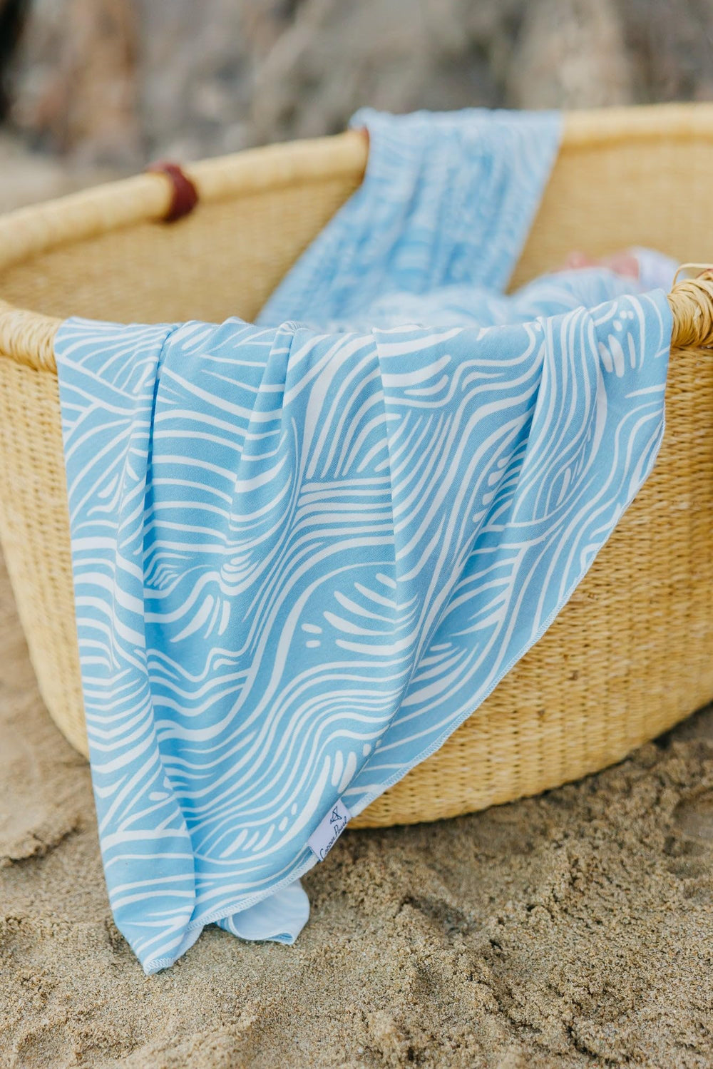 Copper Pearl Surf swaddle blanket machine-washable care for busy households.