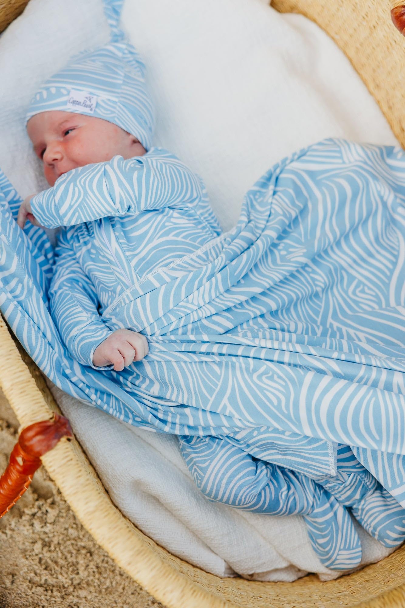Copper Pearl Surf swaddle blanket versatile uses cover, wrap, and shield baby.