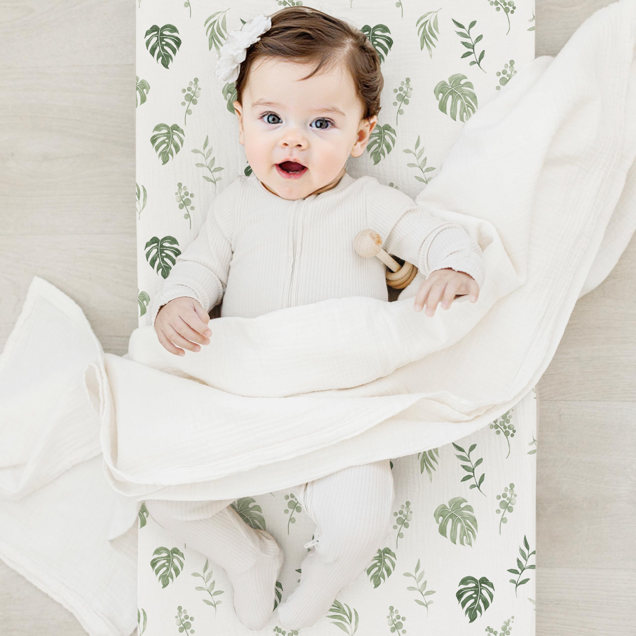 Coreeky leaf-pattern changing pad cover is machine washable for easy nursery upkeep.