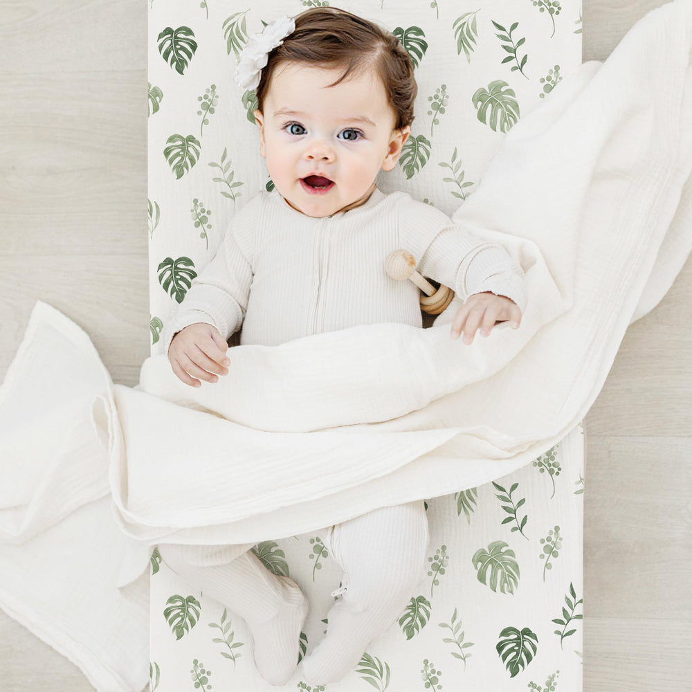 Coreeky leaf-pattern changing pad cover is machine washable for easy nursery upkeep.