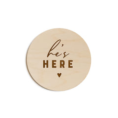 The Cotton & Canvas Co. He's Here newborn disc used as a rustic photo prop.