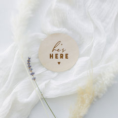 The Cotton & Canvas Co. He's Here wooden keepsake prop for baby's first photos.