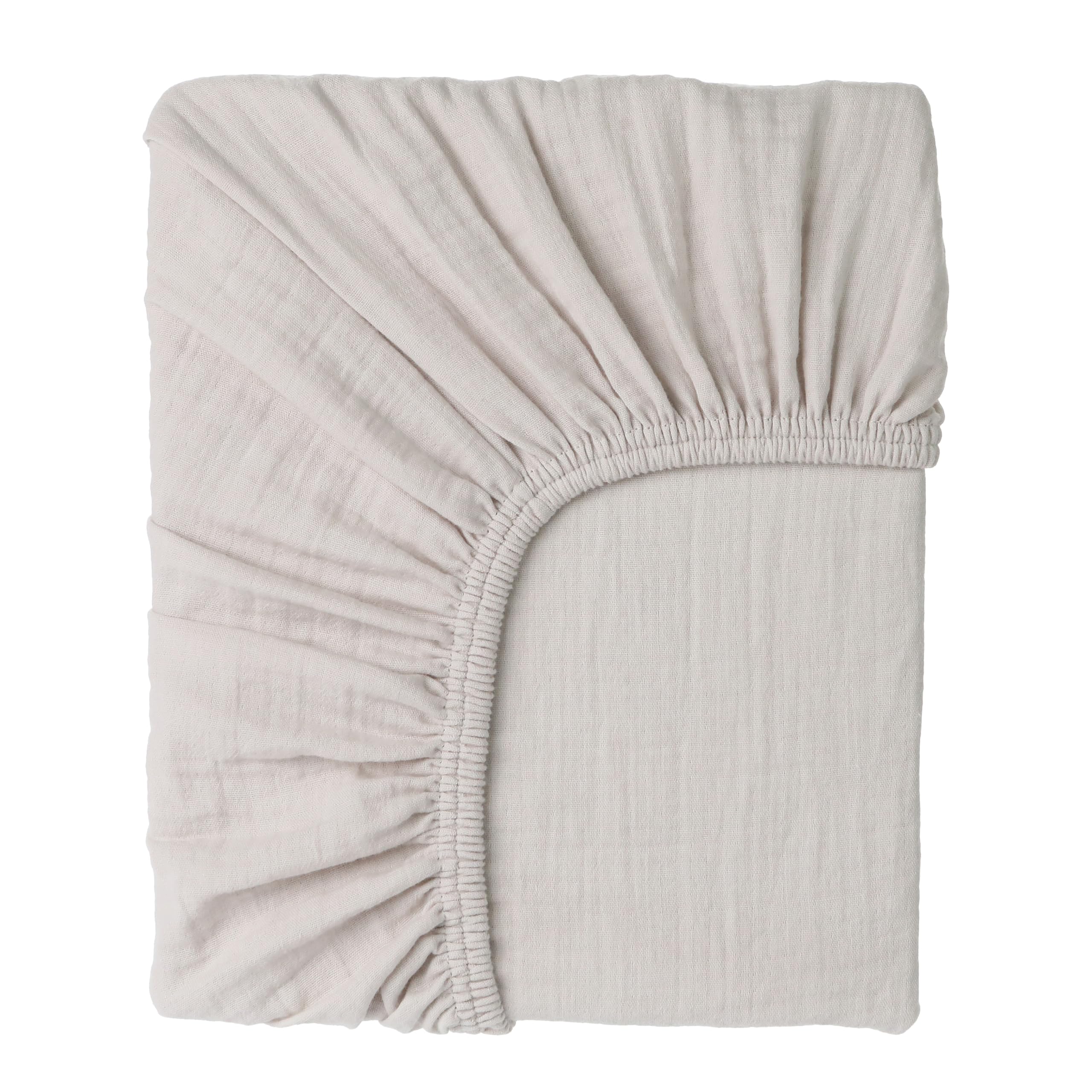 Cottonsis Muslin crib sheet close-up shows ultra-soft fabric for newborn comfort.