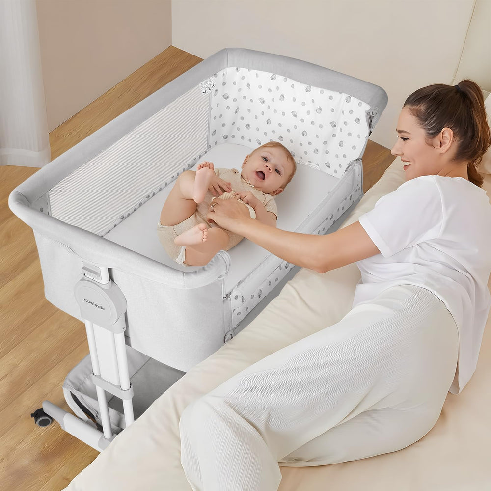 Cowiewie Bassinet bed attachment offers secure bedside use.