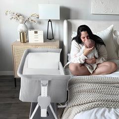Cowiewie bassinet with silent wheels gliding smoothly beside the bed.