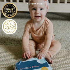 Curious Baby household activities using a mirror, pans, and pillow for exploration.