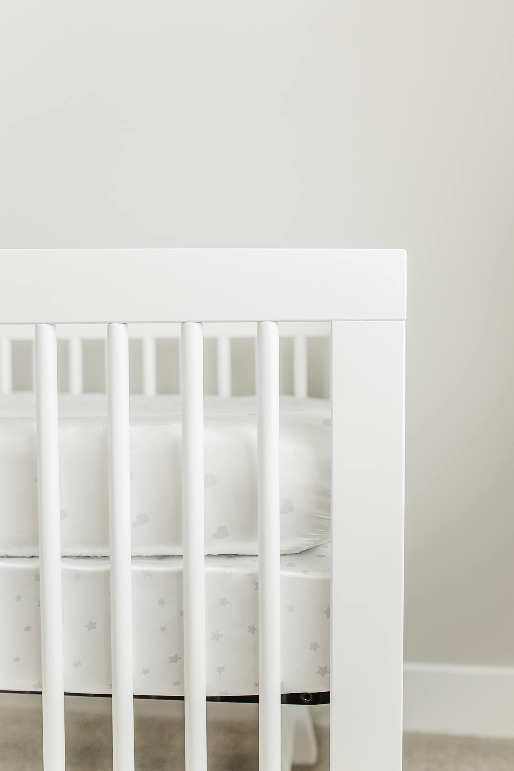 CutieCozy white satin crib sheet with gray hearts design.