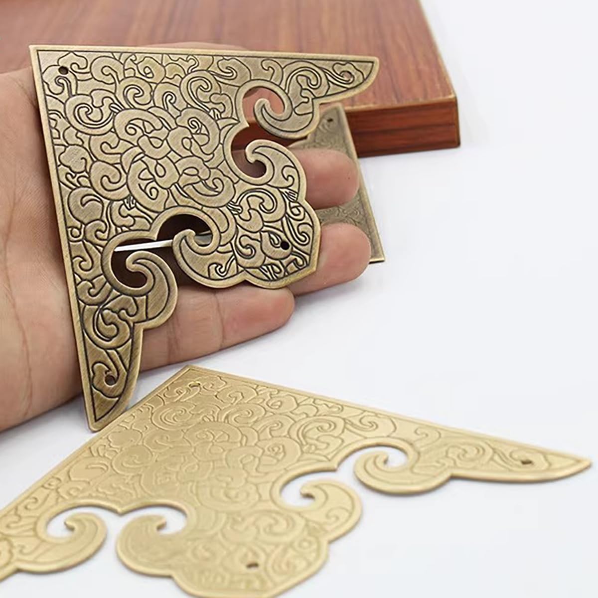 Dasaziya brass corner guards installed on furniture protect edges discreetly.