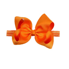 DDazzling baby large hair bow headband orange on head, ideal for photo sessions