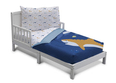 Delta Children blue shark reversible comforter shown in a cozy toddler bed setup