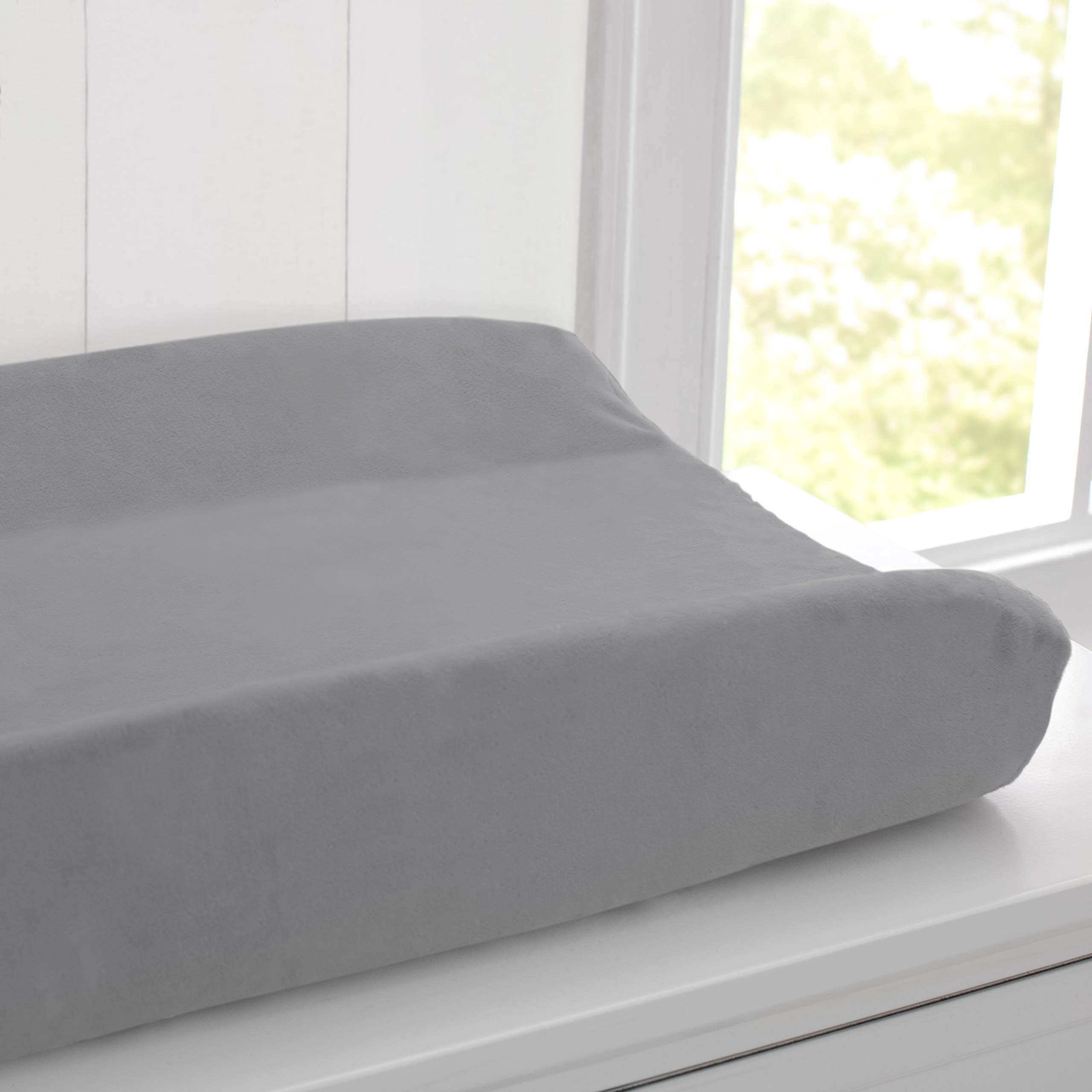 Delta Children changing pad outer vinyl layer is hypoallergenic and waterproof for wipe-clean care