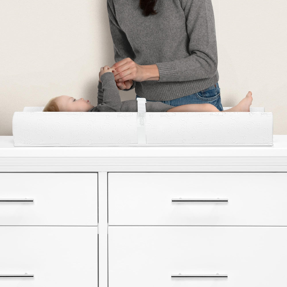 Delta Children Serta pad shows contoured sides for stable support during diaper changes