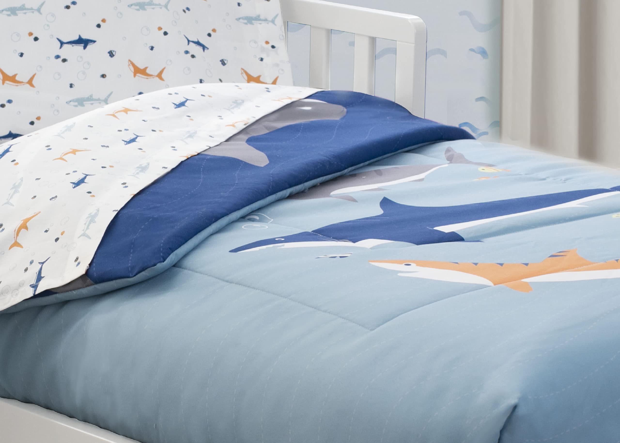 Delta Children toddler bedding setup with playful blue shark theme