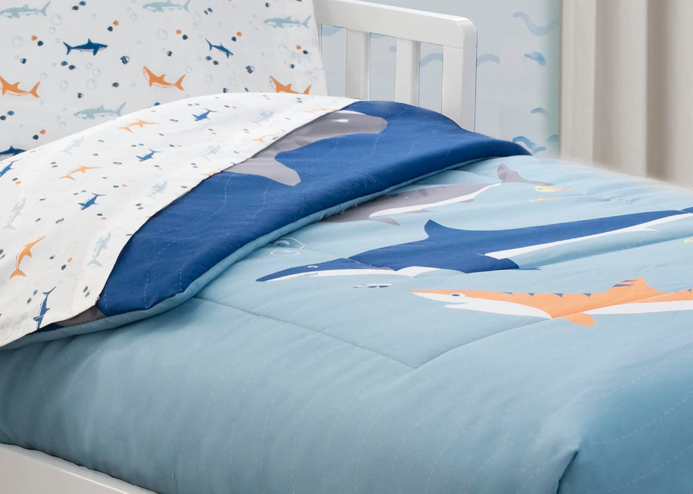 Delta Children toddler bedding setup with playful blue shark theme