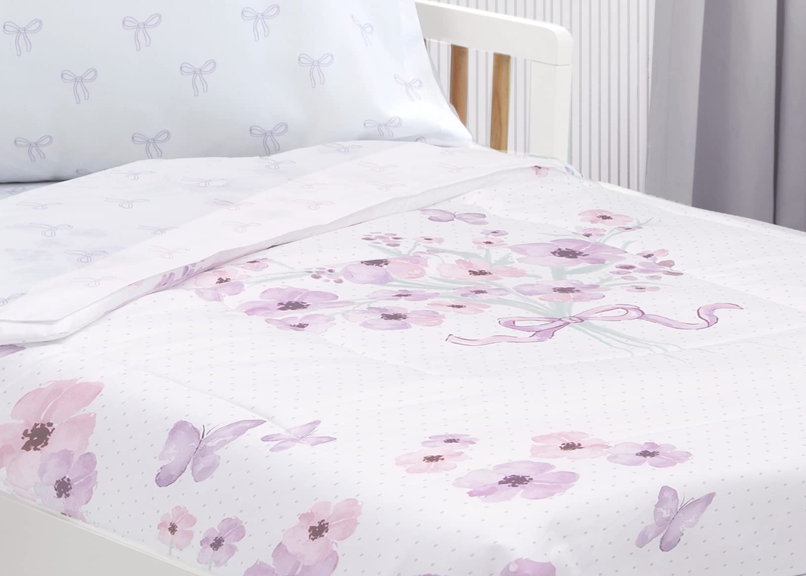 Delta Children purple bouquet bedding in a toddler bed setup