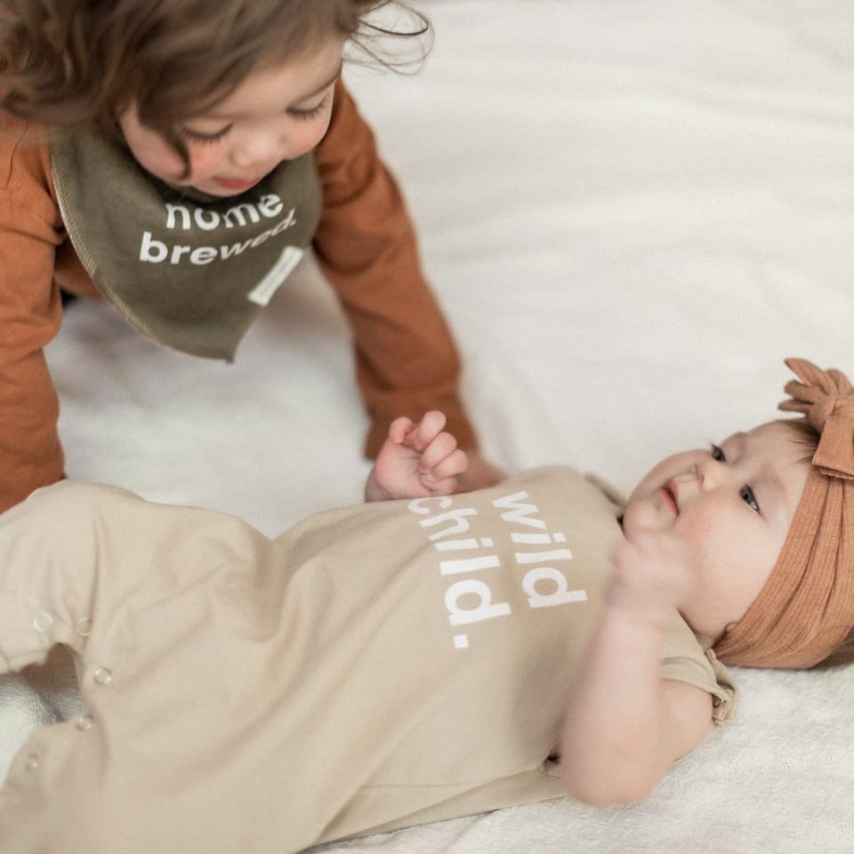 Baby wearing Denver James bib during meal time