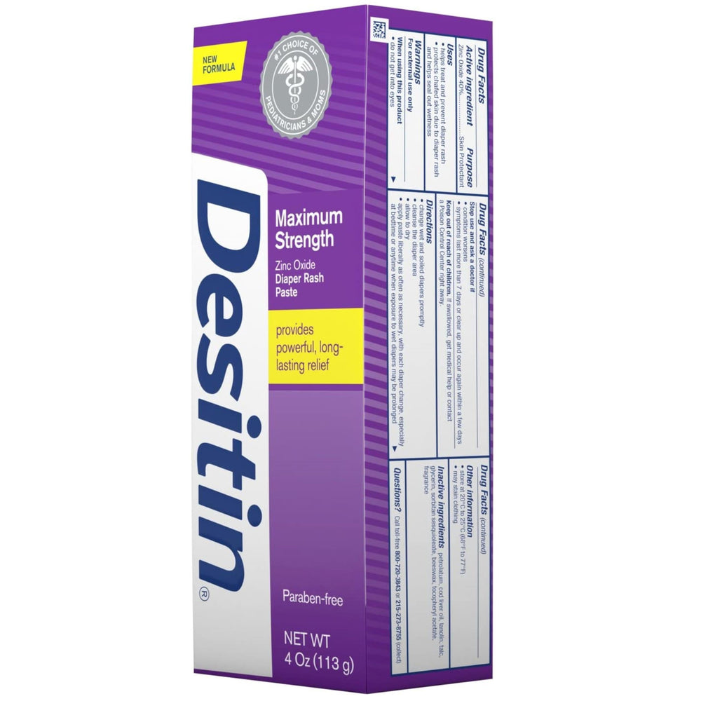 Parent applying Desitin to a baby’s diaper area for possible overnight protection.