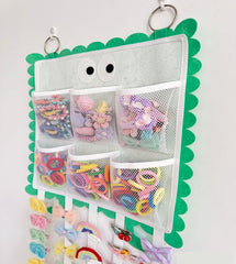Green organizer helps keep scrunchies and clips tidy for easy styling