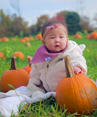 Diaper Squad bibs with teething designs in bright colors for everyday outfits.