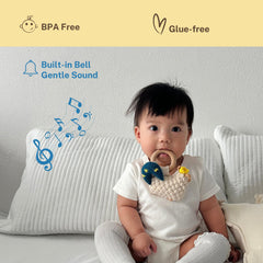 DICHA wood baby rattle with beech teething ring shown for mouthing comfort.