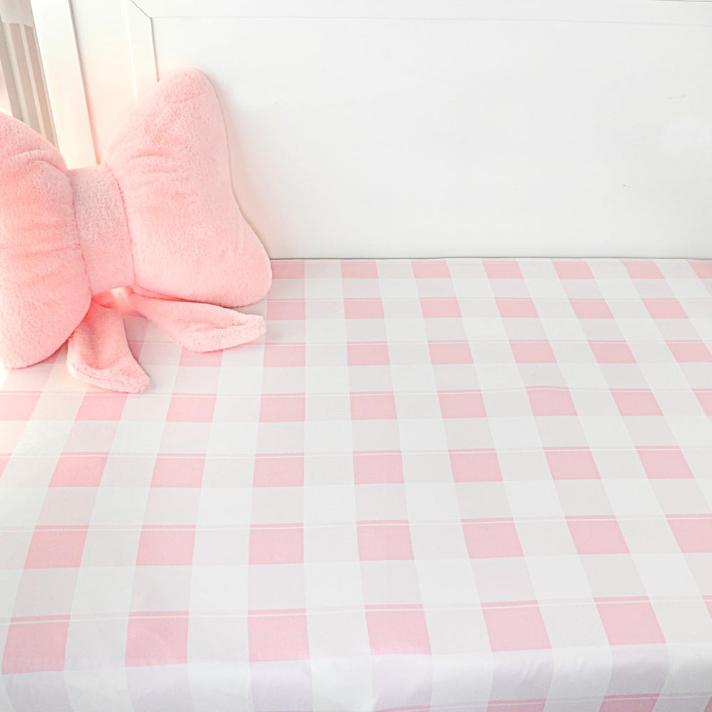 DILIMI pink checkered crib sheet on baby bed for everyday use