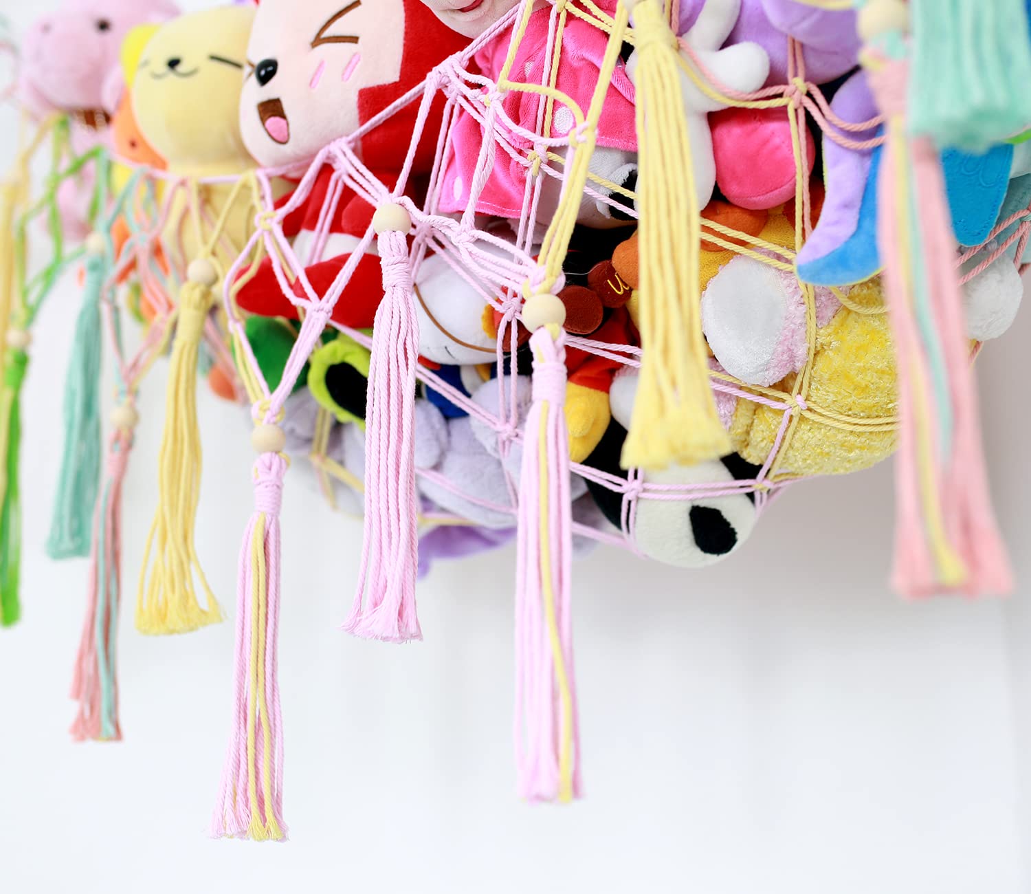 Diocos boho macrame toy hammock display adds cozy charm to a nursery.