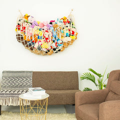 Diocos macrame toy hammock with wooden beads and tassels for decorative storage.