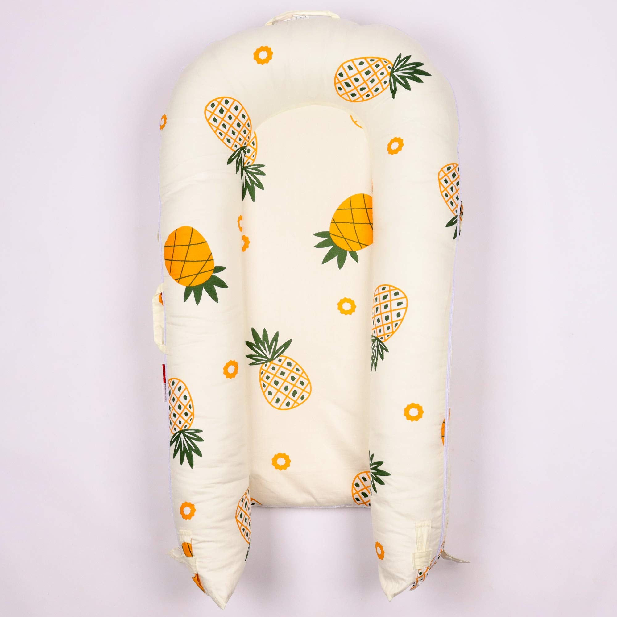 DockATot cover for deluxe lounger shows pineapple motif with 100% cotton softness.