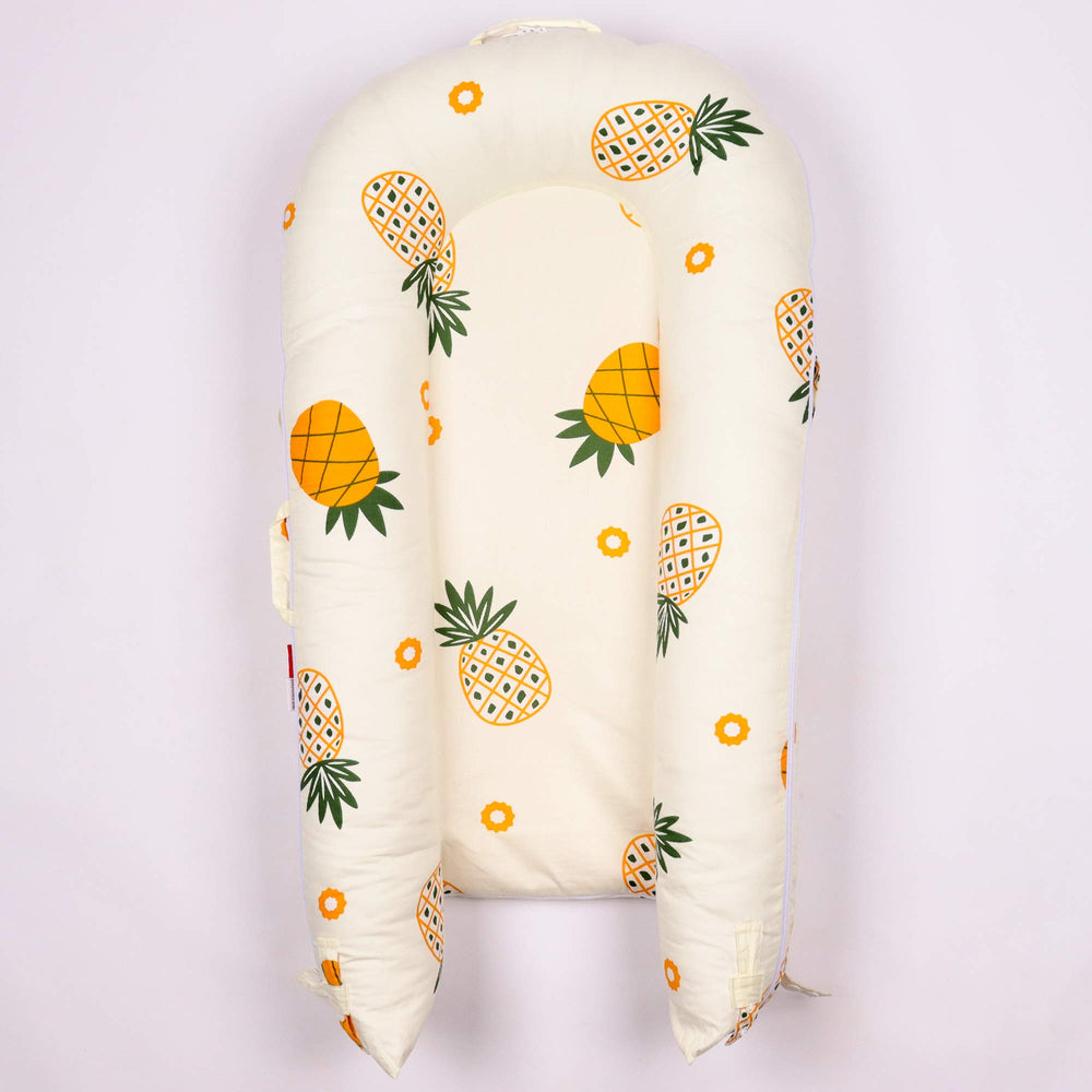DockATot cover for deluxe lounger shows pineapple motif with 100% cotton softness.