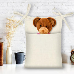 DOITOOL Linen Bedside Hanging Storage Bag holds pacifiers and teethers within easy reach