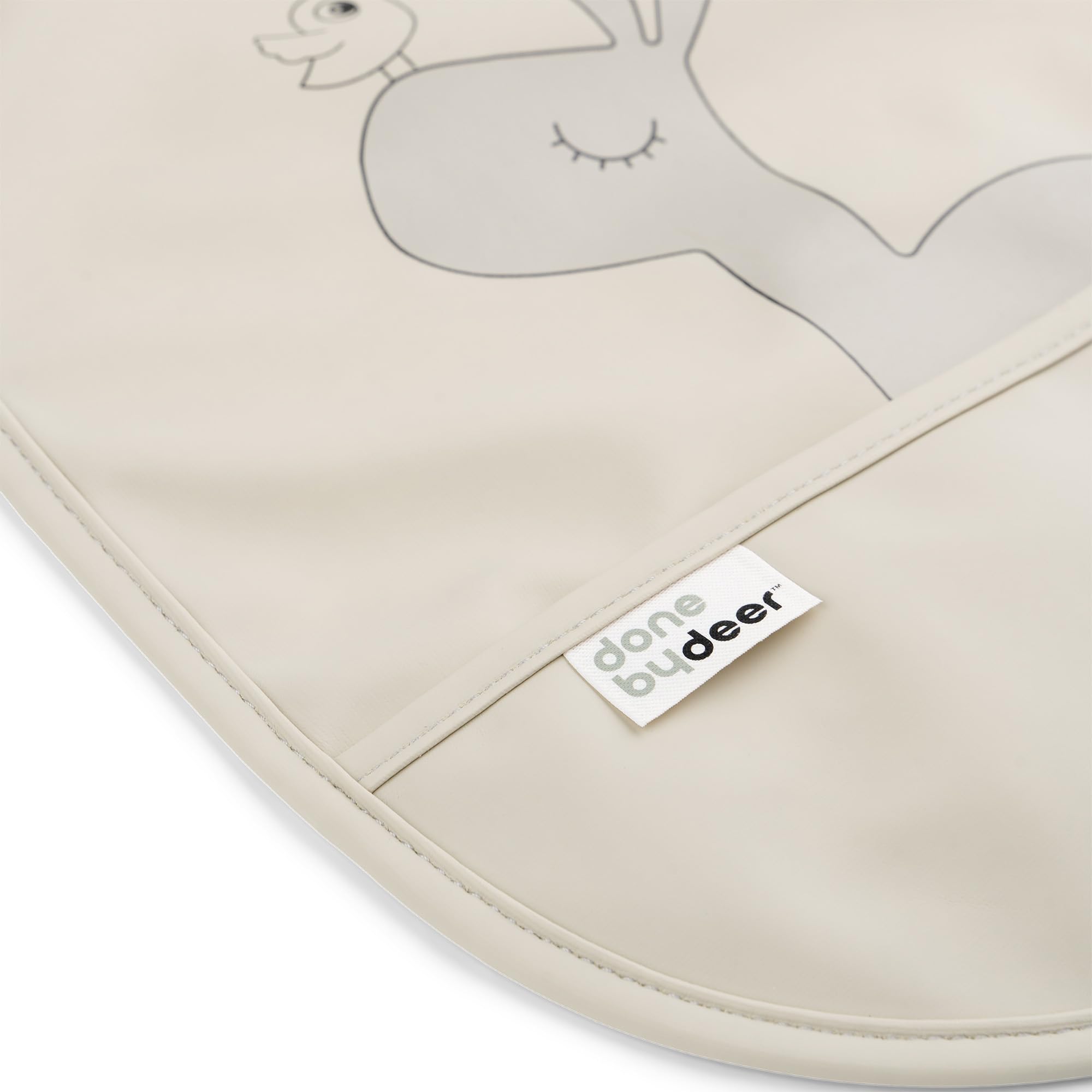 Done by Deer sand bib with Happy dots supports tidy eating and cleanup.