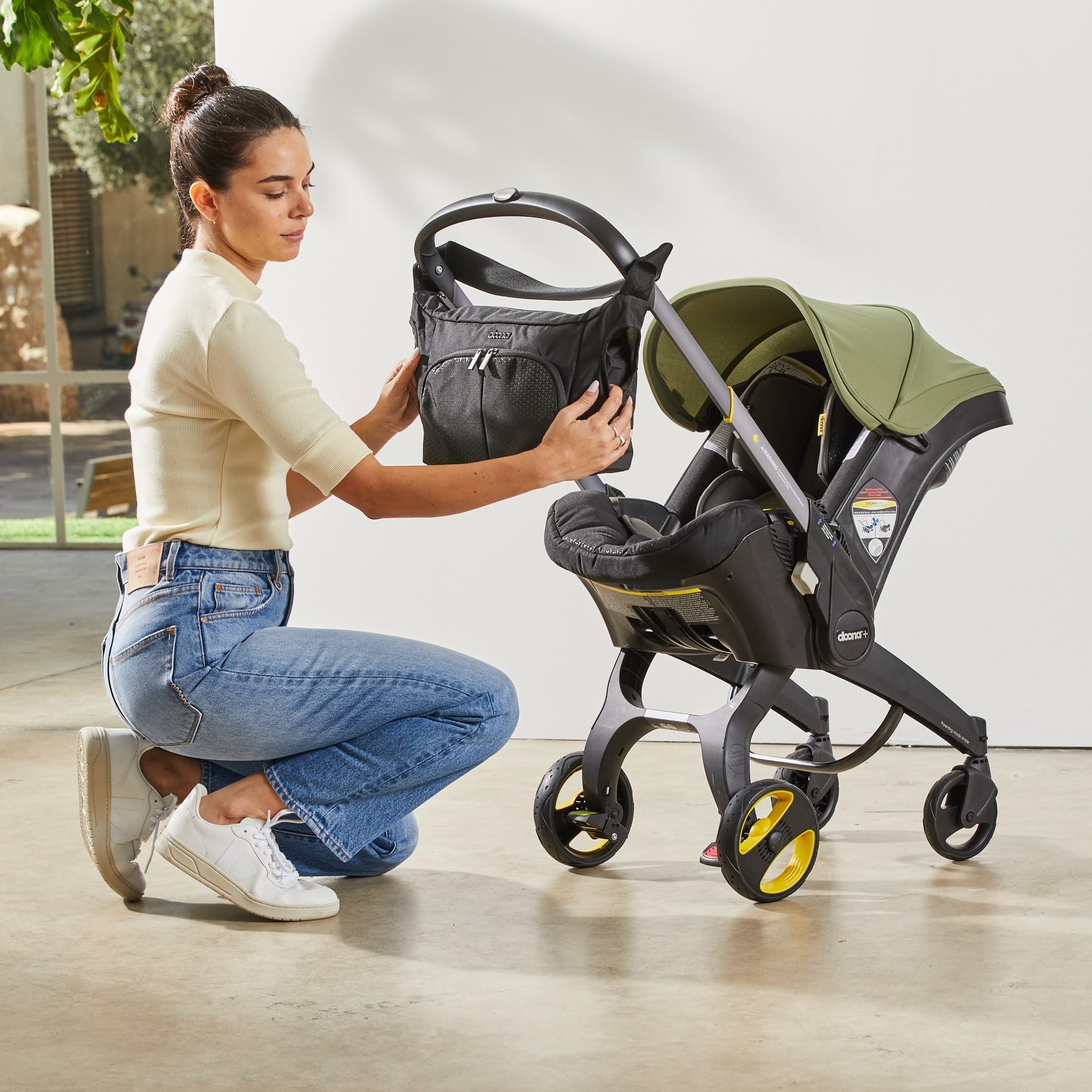 DOONA Essentials Bag includes foldable changing mat for on-the-go diaper changes.