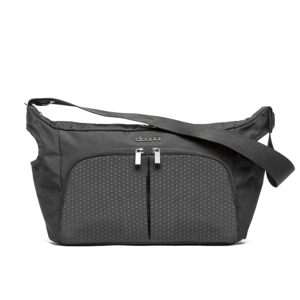 DOONA Essentials Bag Nitro Black attached to the stroller handle for effortless on-the-go storage.