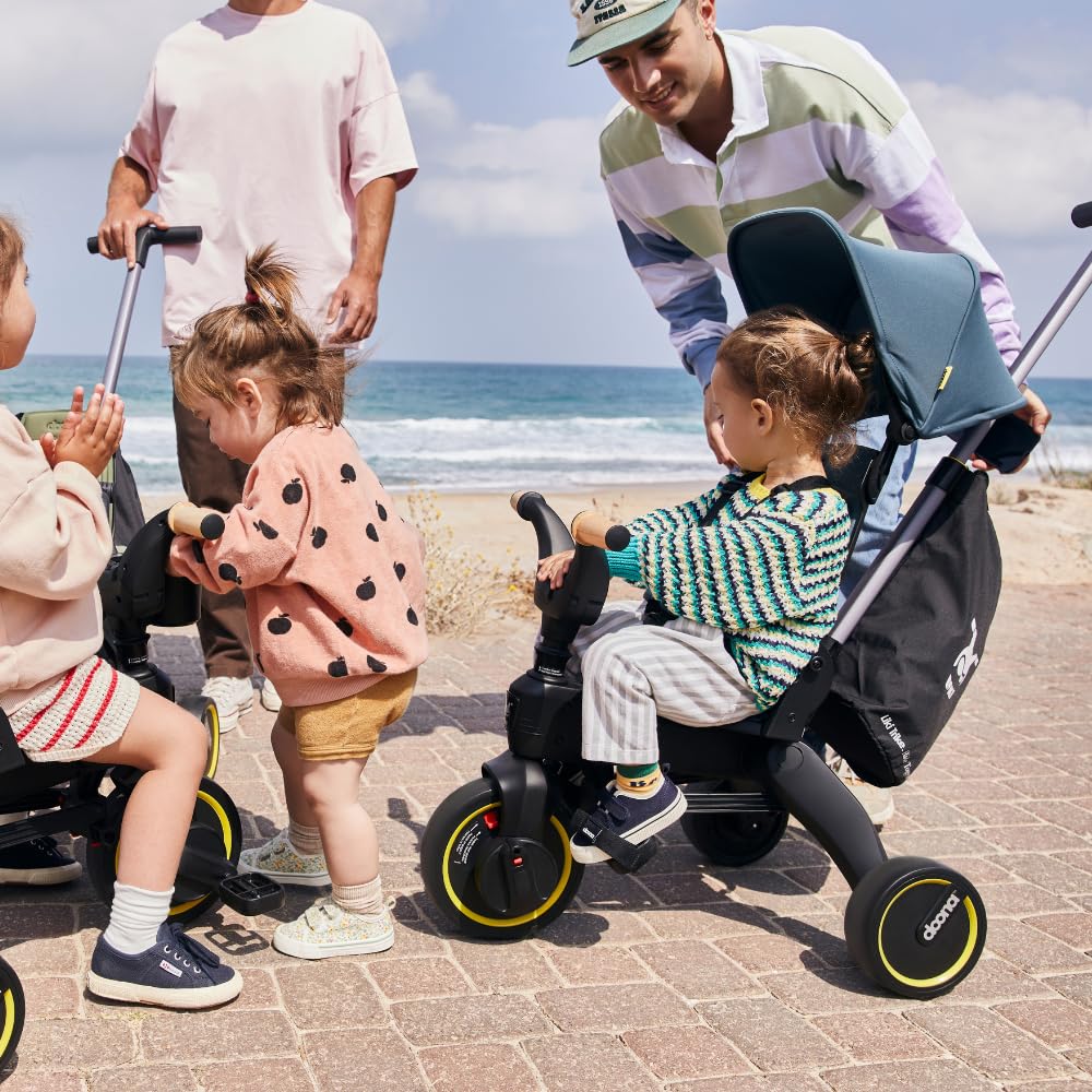 DOONA Liki premium storage bag mounted on a trike during a family stroll.