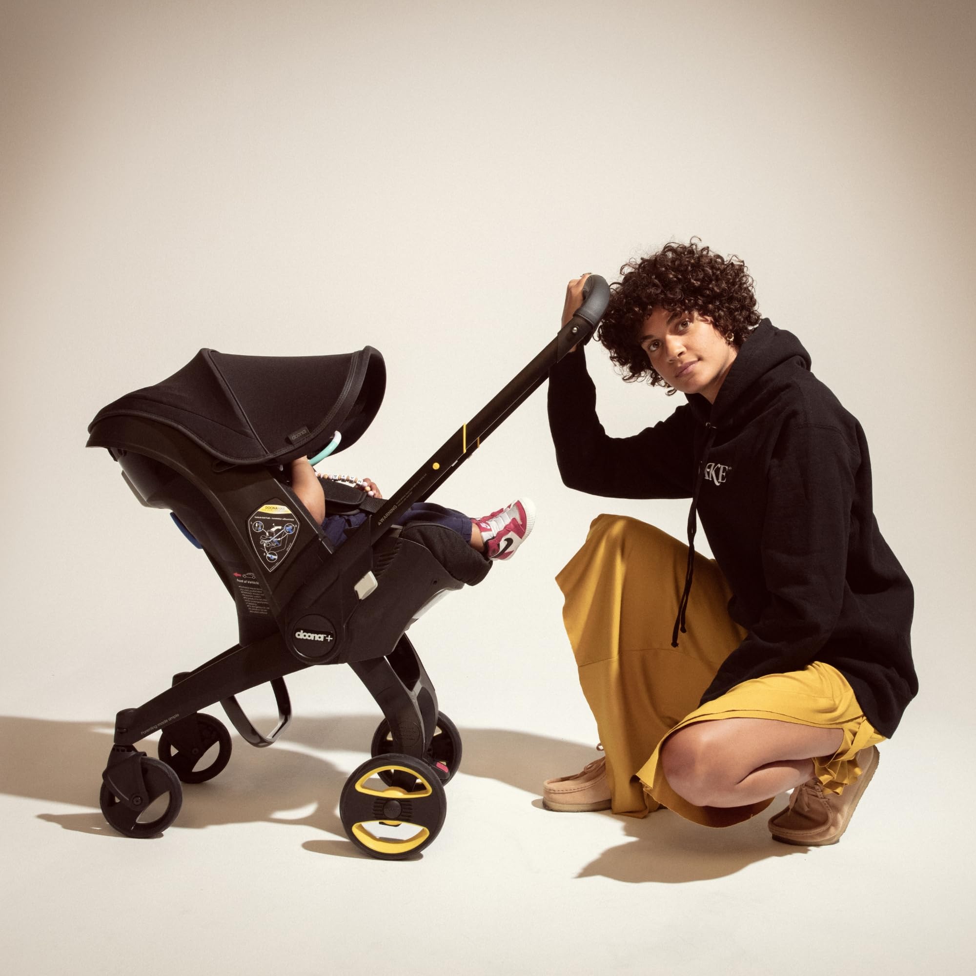 Doona Midnight Edition infant insert supports newborn posture during travel.