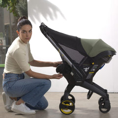 DOONA Sunshade Extension in the car shields direct sunlight during rides.