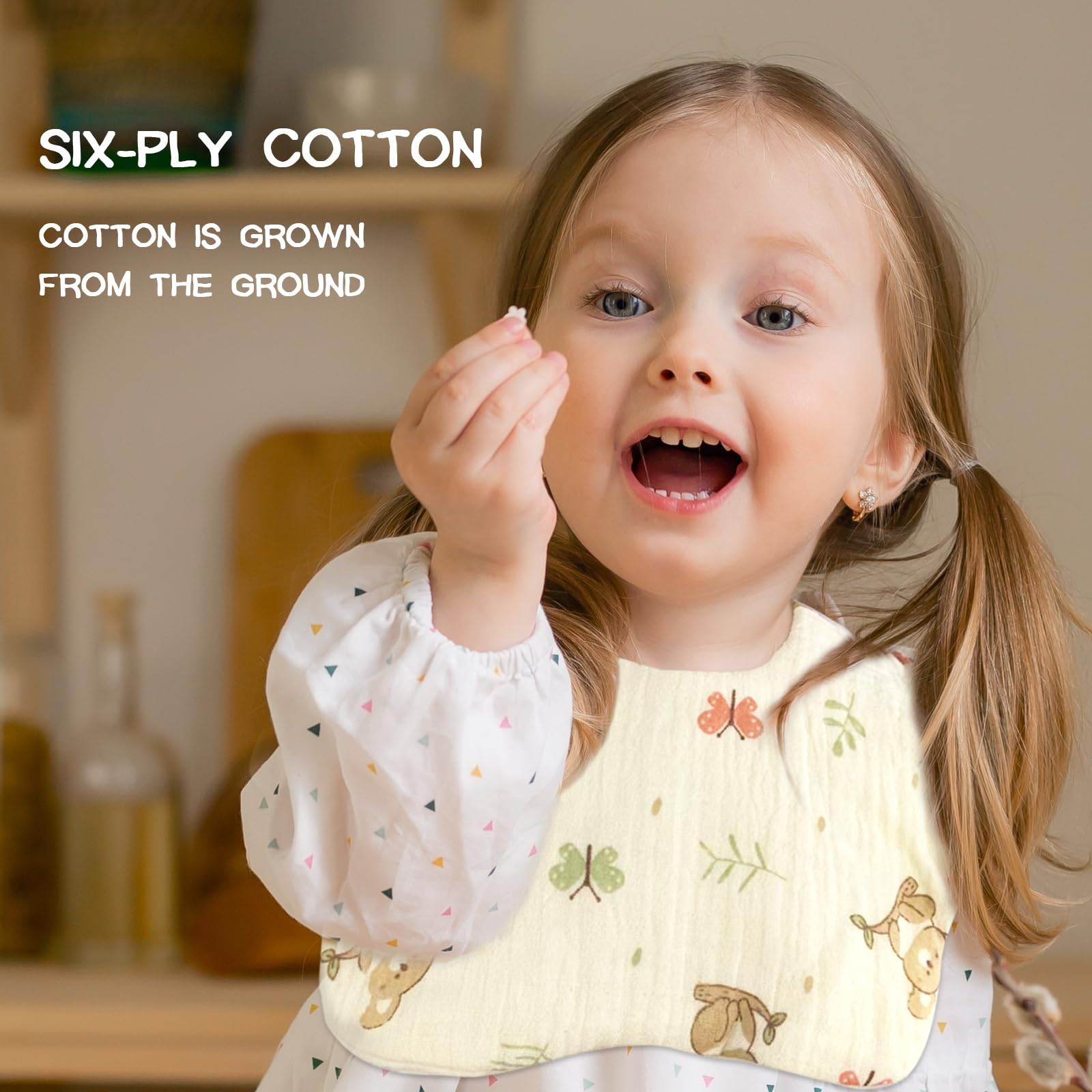 Travel-friendly cream bibs roll up neatly for on-the-go feeding