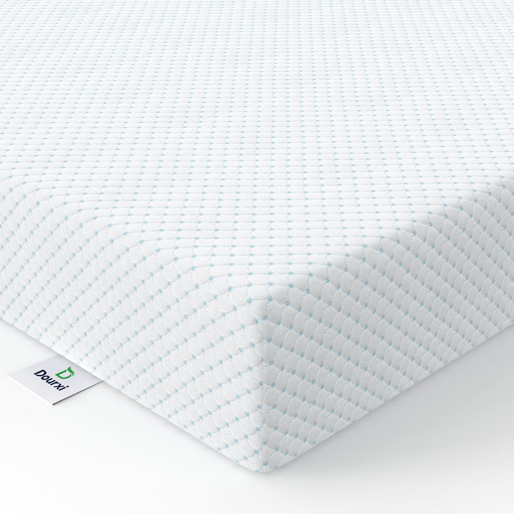 Dourxi mini crib mattress top view, showing a snug fit for compact cribs
