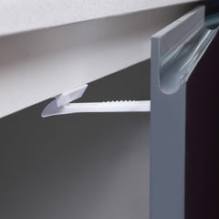 Dreambaby latch in use seals cabinet doors for safer kitchen activities