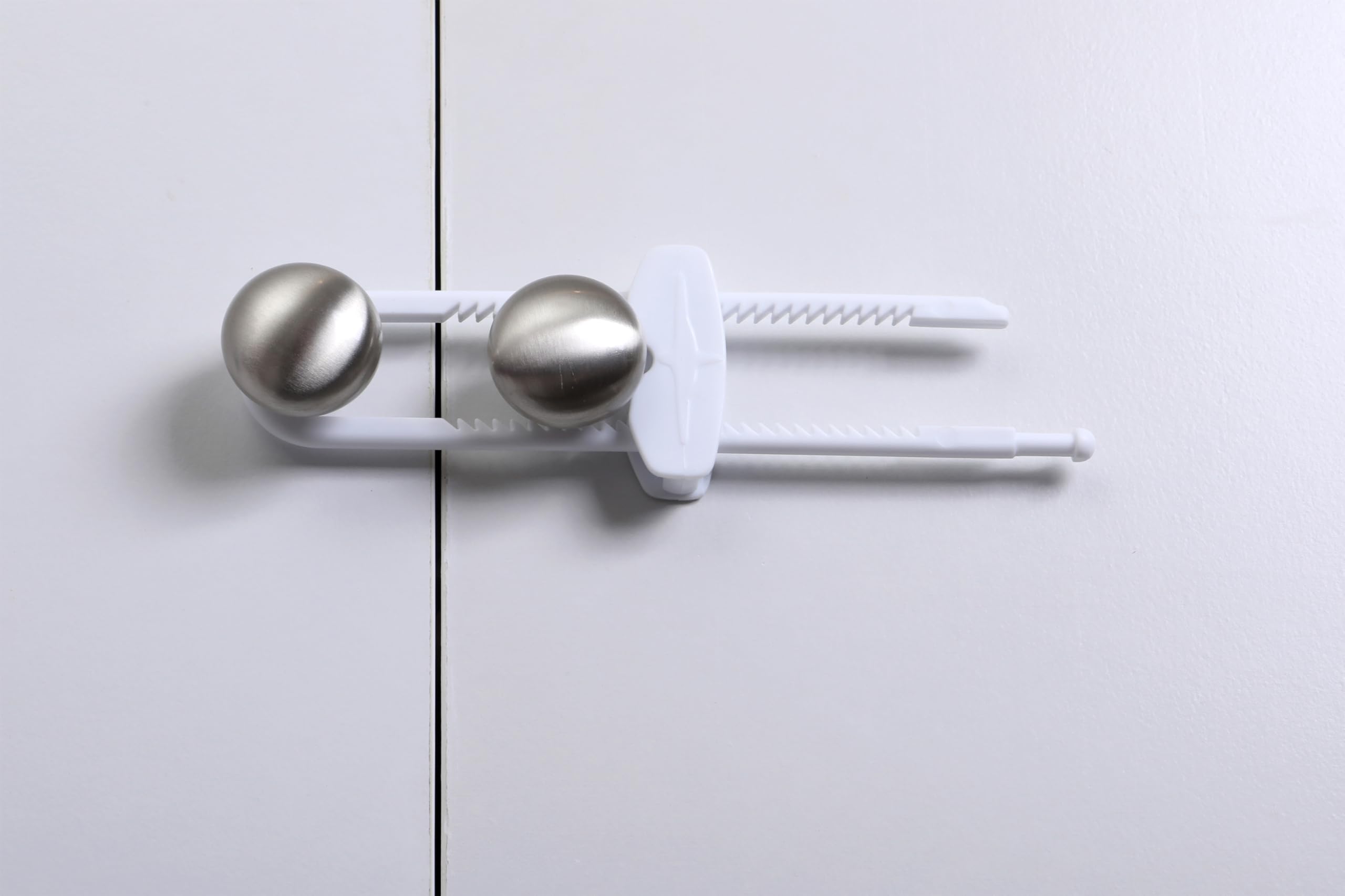 Dreambaby sliding locks securing kitchen cabinets, ideal for cluttered spaces