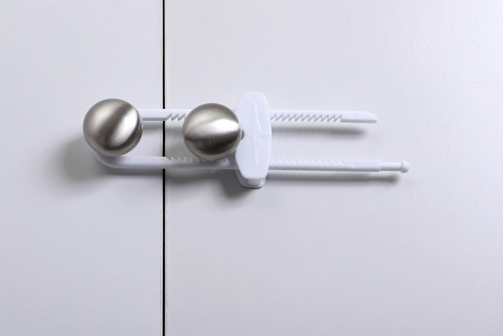 Dreambaby sliding locks securing kitchen cabinets, ideal for cluttered spaces