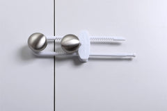 Dreambaby sliding locks on mushroom handles demonstrate universal fit for cabinets.