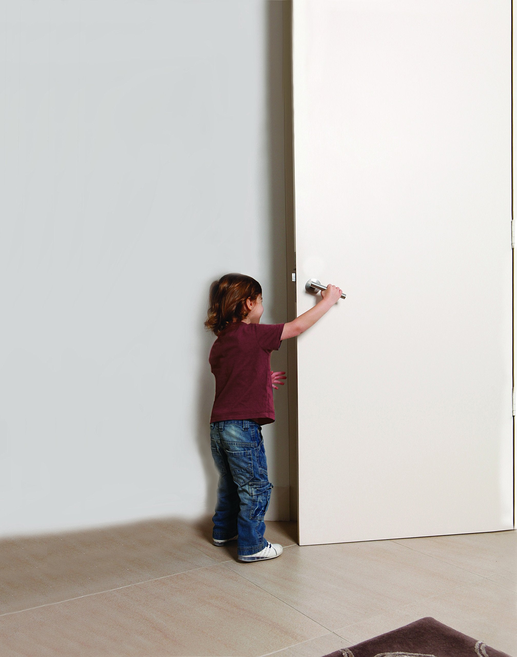 Dreambaby Under Door Gripper on wood floor prevents doors from closing abruptly.